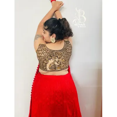 A creative pose showing off the beautiful peacock and jaal pattern mehndi I created to look like a blouse design.