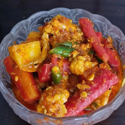 The famous winter special, Gajar Gobhi Shalgam achaar. It has a lovely khatta-meetha taste from the fresh carrots, cauliflower, and turnips mixed with jaggery and spices. It's a seasonal favorite that sells out fast.