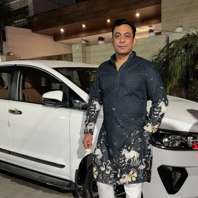 A client looking stylish in a custom-printed black kurta. The unique design featuring horses and birds adds an artistic touch to this traditional garment, making it perfect for a festive occasion.