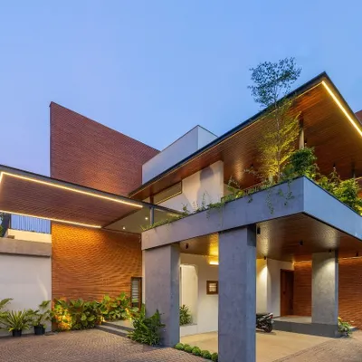 The facade of the Madani Residence showcases our approach to modern tropical architecture. We used a combination of brick cladding, exposed concrete, and integrated greenery under dramatic rooflines to create a dynamic and welcoming entrance.