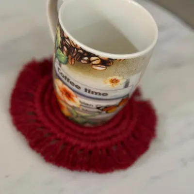 My macrame coasters are perfect for your daily cup of coffee or tea. This red fringed coaster adds a pop of color and protects your tabletop in style.