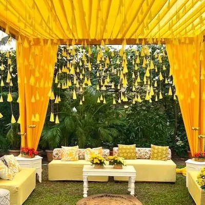 A classic and cheerful Haldi ceremony setup in a garden. We used bright yellow drapes, hanging marigold tassels, and comfortable seating to create a perfect, sun-kissed ambiance for this pre-wedding event.