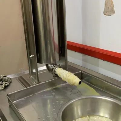 This is where the magic happens. Our sausage stuffer in action, filling the casings with our carefully prepared pork mince mixture. This hands-on process ensures quality in every link.