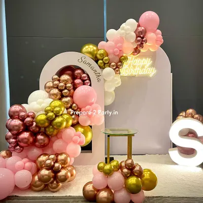 This premium birthday backdrop was personalized with the name 'Samantha' on a custom arched panel. The design features a cascading balloon garland in pink, rose gold, and white, a 'Happy Birthday' neon sign, and a light-up marquee initial.