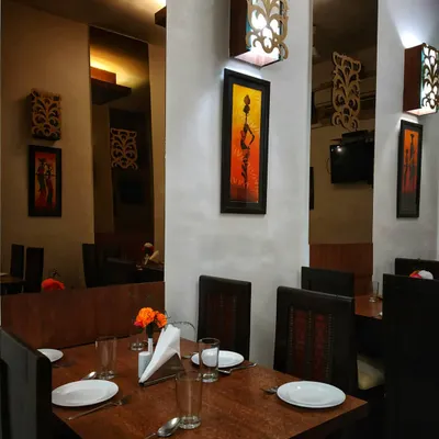 A glimpse of my dining space in Greater Kailash 1. It's designed to be a warm and inviting place for you to enjoy an authentic Indian meal, whether it's a family dinner or a quiet evening out.
