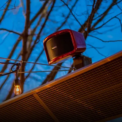 This vibrant red Void Cyclone 55 outdoor speaker adds a pop of color and powerful sound to this terrace setup. It's designed to be completely weatherproof, so the music plays on, no matter the forecast.