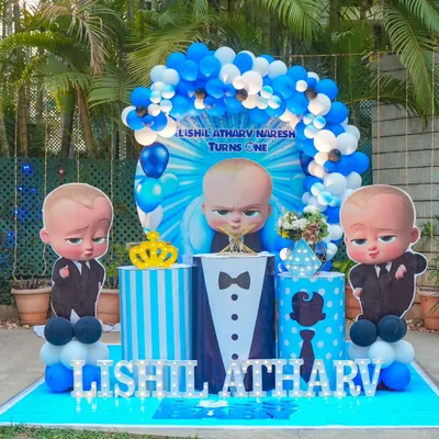 Who's the boss? Lishil Atharv is! This outdoor Boss Baby theme is sharp and stylish, featuring a central cutout of the boss himself, flanked by two more. The blue and white color scheme, tuxedo-themed pedestal, and striped details create a fun, corporate-chic vibe.