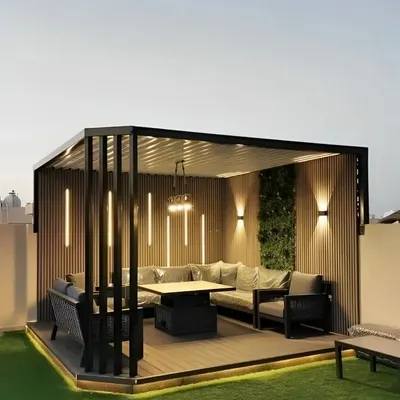 This rooftop seating area was designed for evening entertaining and relaxation. We built a modern pergola with integrated vertical lighting and installed a large, comfortable sectional sofa. The design creates a cozy, room-like feel, making it a true extension of the home.