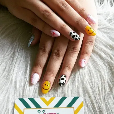 This mismatched set is all about fun. I hand-painted smiley faces, cow print, a pink checkered pattern, and tiny hearts to create a playful and happy vibe on these rounded nails.
