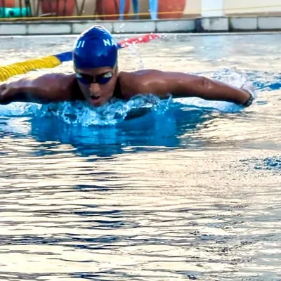 The butterfly stroke, a perfect synthesis of power and rhythm. This action shot highlights the muscular development and technical proficiency we instill in our competitive swimmers through rigorous, focused training.
