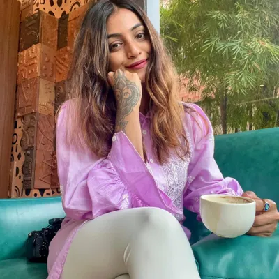 Taking a moment to enjoy a good cup of coffee. I'm wearing a comfortable lavender blouse and white leggings, my idea of a perfect, relaxed cafe look.