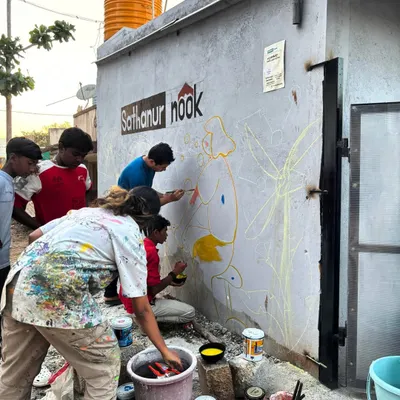 The beginning of every community mural is a mix of chalk lines and shared excitement. Here at Sathanur Nook with Project Defy, we started by outlining the vision, with community members of all ages eager to start painting and bring their wall to life.