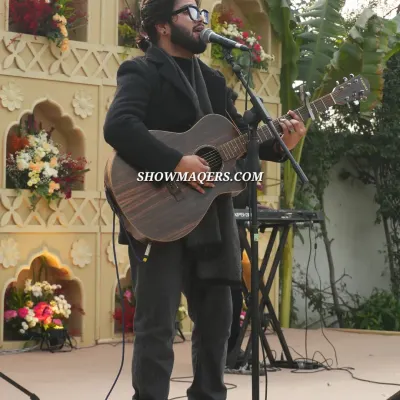 A soulful singer and guitarist performing at the Banaras themed event, providing the perfect musical backdrop.