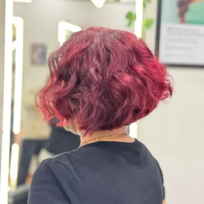 A chic warm wine color on a modern bob cut. This back view shows how the rich, vibrant tones and precision cut work together to create a bold and stylish statement.