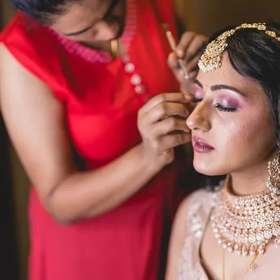 A behind the scenes shot of me working on a client's eye makeup. I take great care in every step, from blending the eyeshadows to placing the lashes, to create a look that is both beautiful and comfortable to wear.