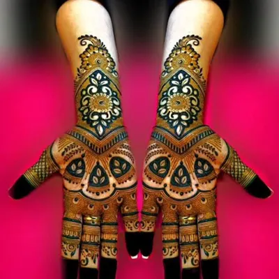 A striking design with bold, symmetrical patterns. The use of dark henna for the outlines and negative space makes the intricate details pop, creating a very modern and graphic look.