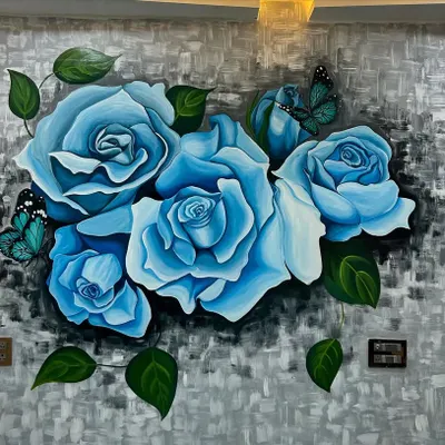 A close-up of a custom floral mural I painted for a client's home. The soft blue roses and delicate butterflies create a serene and beautiful focal point in the room.