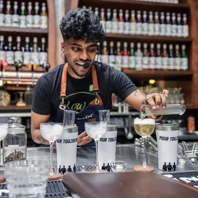 Preparing a flight of "Pour Toujours" cocktails for a competition. This image shows the setup for creating multiple, consistent, high-quality drinks under pressure.
