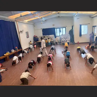 A typical conditioning drill in our kids' Taekwondo class. These exercises are crucial for building the core strength, flexibility, and endurance needed for martial arts.
