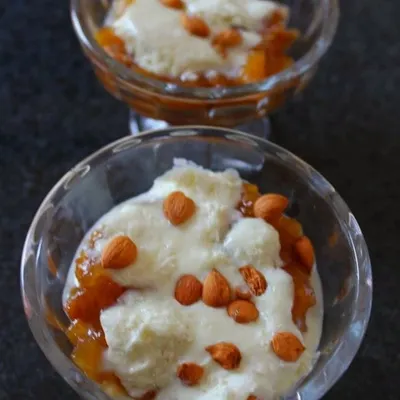Our famous Apricot Delight, also known as Khubani ka Meetha. This Hyderabadi dessert features stewed apricots topped with fresh cream or custard and garnished with almonds, offering a perfect balance of sweet and tangy flavors.