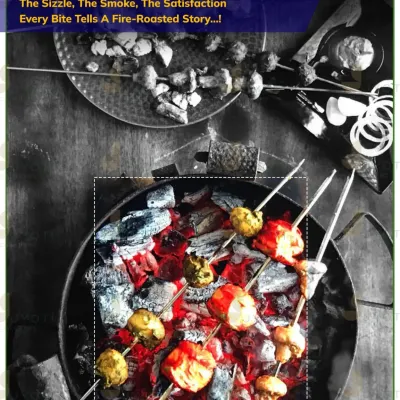 The sizzle and smoke of a live tandoor station. Here, skewers of paneer and mushroom tikka are fire-roasted over hot coals, delivering authentic flavour in every bite.
