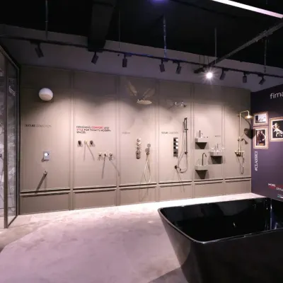A wide view of the Fima showroom I designed in Gurgaon, showcasing an immersive experience with premium shower systems and a freestanding black bathtub.