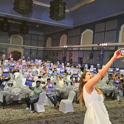 A selfie with a room full of 200 happy painters. Capturing moments like this is not just for memories; it's powerful social proof. I teach how to leverage these visuals to build credibility and attract bigger clients.