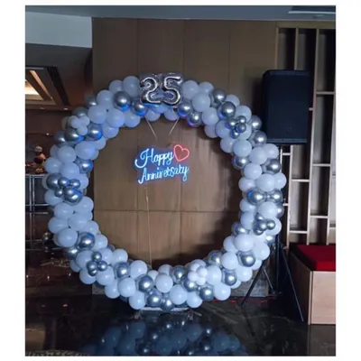Celebrating a silver jubilee is a huge milestone. For this 25th anniversary, I created a large balloon ring in silver and white, with a "Happy Anniversary" neon sign at the center to serve as a perfect photo spot for the happy couple.