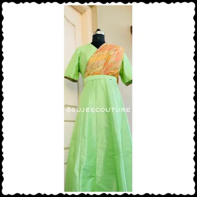 This is a full-length view of a custom-made long gown in a lovely light green silk. I designed this piece with an attached, pre-draped dupatta in a contrasting print, so your little one gets a sophisticated look without any fuss. It’s a perfect example of a comfortable, one-piece occasion wear outfit.