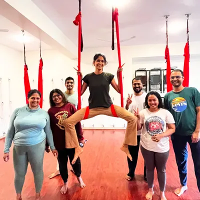 The smiles say it all! This is a typical moment from one of my adult aerial yoga classes, full of fun, strength, and great energy. I'm in the middle, guiding the group through a playful pose.