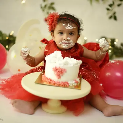 The best part of a cake smash is the pure, messy joy. This little one is having a blast, and I was right there to capture her adorable, frosting-covered smile. These sessions are all about fun.