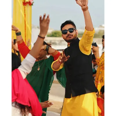 The groom enjoying a candid dance moment during the Haldi ceremony. It's the uninhibited joy and energy of these celebrations that I love to document.