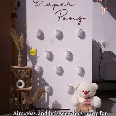 Aim, toss, and let's see who's ready for diaper duty! Our "Diaper Pong" game is always a huge hit at baby showers, bringing out everyone's competitive and fun side.