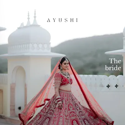 A bride framed against the majestic domes of a Rajasthani palace. We use the grandeur of the location to create breathtaking, wide-angle portraits that feel truly royal.