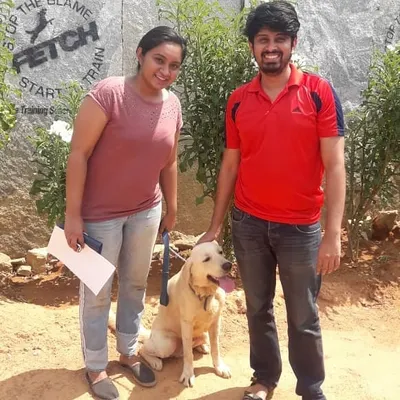 A happy Labrador and his proud owners graduating from the Fetch program. Every dog that leaves here does so with a new, common language to communicate with their owner.