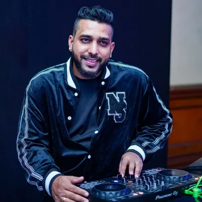 A candid shot of me at the console. I'm not just playing music; I'm focused on crafting a seamless experience for the audience.