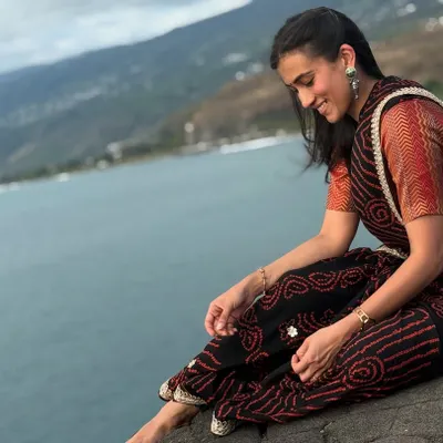 Modeling a beautiful bandhani saree against the backdrop of the black sand beaches in Saint Paul. The natural setting adds a serene and organic feel to this ethnic look.