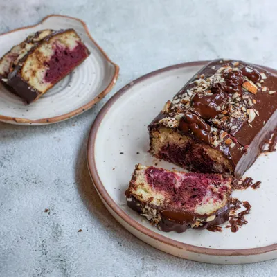 Our new Marble Cake is a classic for a reason. This loaf features swirls of vanilla and rich red velvet cake, all coated in a decadent chocolate glaze and topped with toasted almonds.