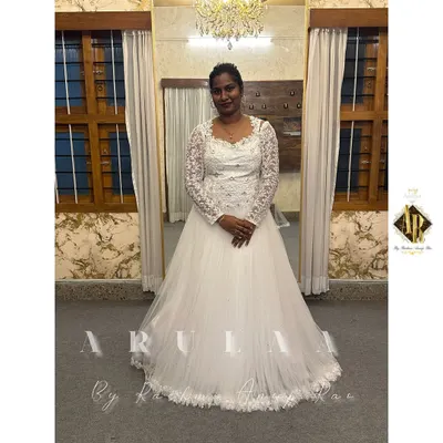 Our gorgeous Mangalore bride in her custom white wedding gown. We designed this elegant piece with a full tulle skirt and a delicate lace bodice and sleeves.