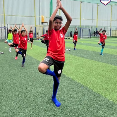 Our young players practicing the tree pose during our World Yoga Day celebration, finding balance and focus.