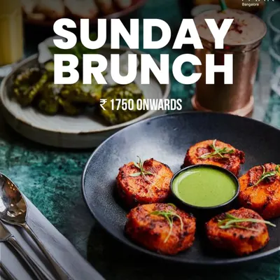 Our Sunday Brunch is the perfect way to end the weekend. This image showcases some of the delicious appetizers you can enjoy, from tandoori bites to fresh salads, with packages starting from ₹1750.