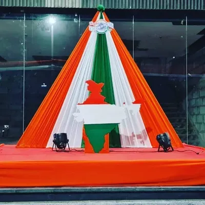 A powerful stage setup for a Republic Day event, using tricolor drapes to create a tent-like structure over a cutout of the map of India. This design is ideal for formal functions and stage performances.