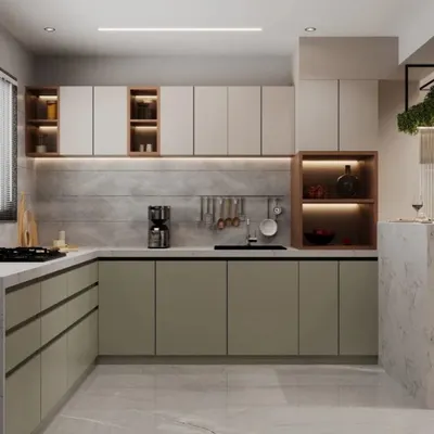 A sleek L-shaped kitchen design featuring two-tone cabinetry in sage green and beige. Under-cabinet lighting illuminates the workspace, while a mix of open and closed storage provides both display and practical utility.