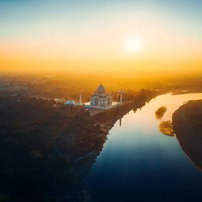 The Taj Mahal at sunset, captured from a safe and legal distance with my drone. The golden light paints the monument and the Yamuna river, creating a soulful and ethereal image of this symbol of love.