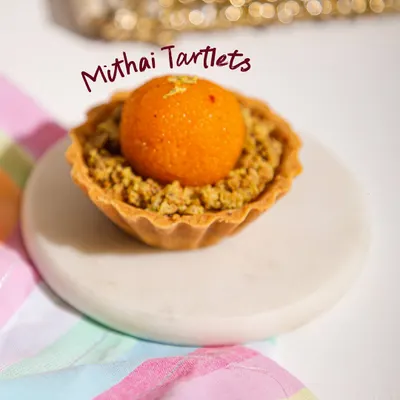 A little twist on tradition. Our Mithai Tartlets, like this Motichoor Ladoo Tart, combine festive Indian flavours with classic patisserie finesse.