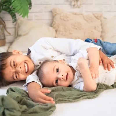 The best of brothers. This photo captures a moment of pure, goofy fun between two siblings during their relaxed, boho-themed studio session.