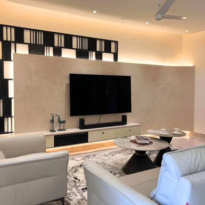 For Harshita and Ankit's living room, I designed this TV wall with a soft, textured finish and a bold geometric frame, adding depth without stealing the spotlight.