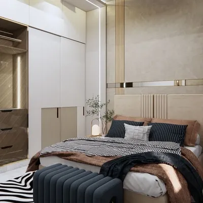 This master bedroom is a sanctuary of minimalist elegance. We used soft neutral tones, luxurious fabrics, and sleek custom cabinetry with gold accents to create a serene and inviting ambiance for relaxation.