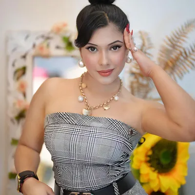 A confident, high-fashion look featuring a plaid tube top and a Valentino belt. This shot is perfect for luxury fashion and accessory brands seeking a model with a sophisticated and elegant presence.
