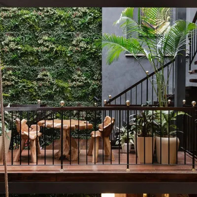 A hanging garden on the staircase landing of our Utopia project, set against a lush vertical garden wall. This is a core example of our biophilic approach, transforming a transitional space into a living, breathing part of the home.